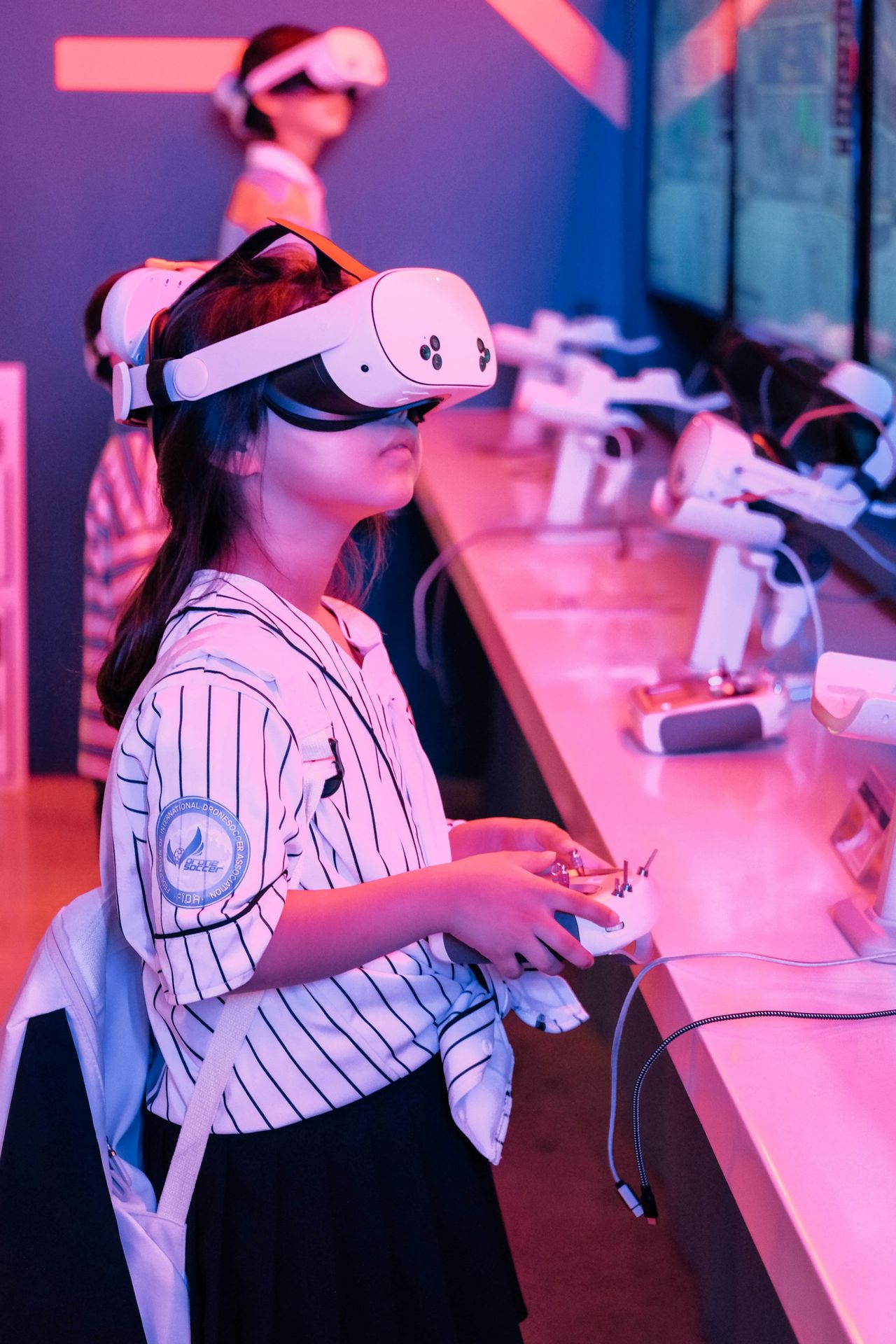 Girl wearing vr headset plays game with controller