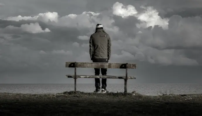 man standing near bench